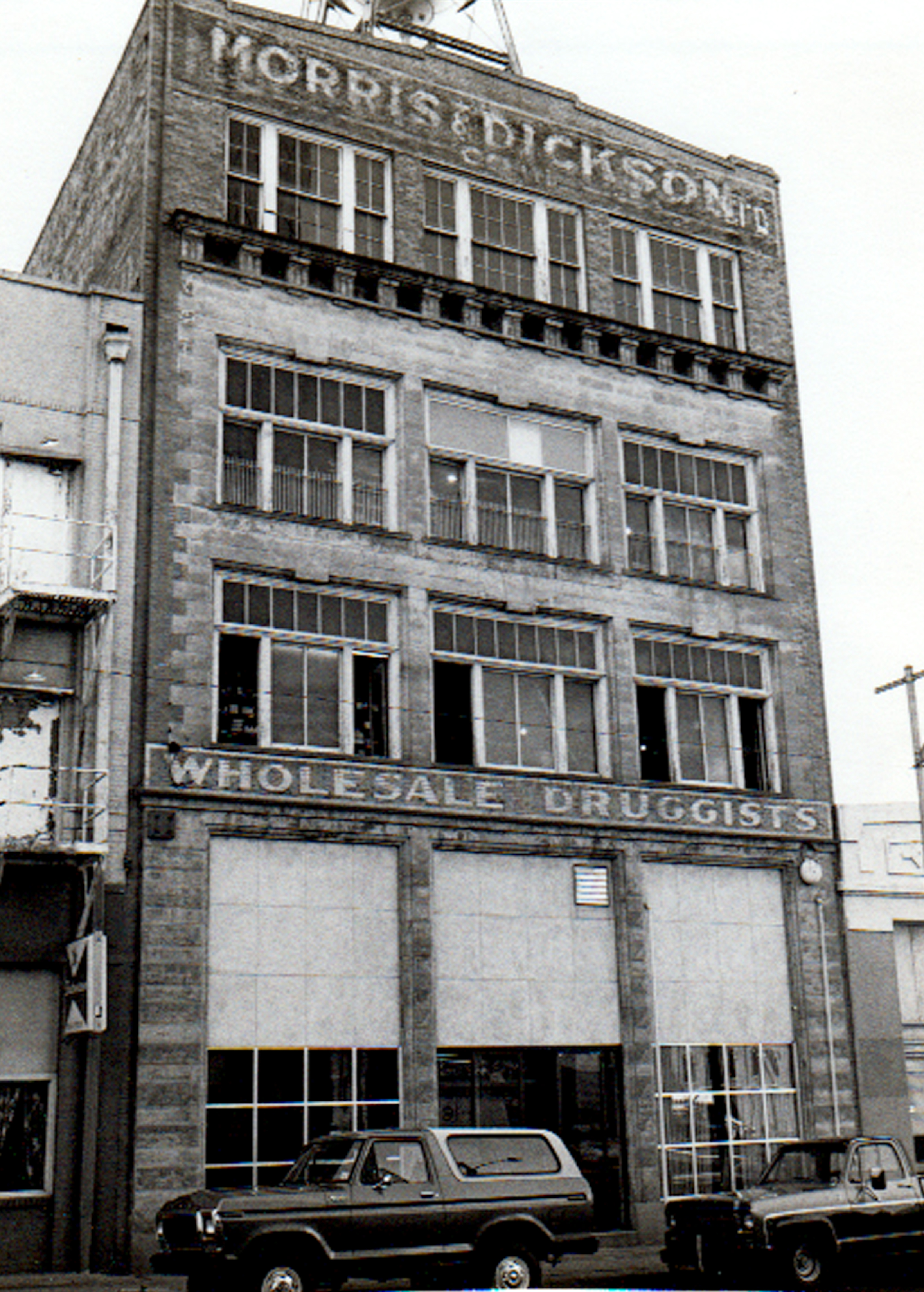 black and white photo of old brick building of Morris & Dickson drug store in Shreveport, Louisiana